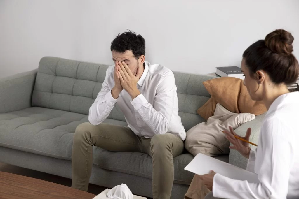 A young person with anxiety talks with a mental health specialist during a session