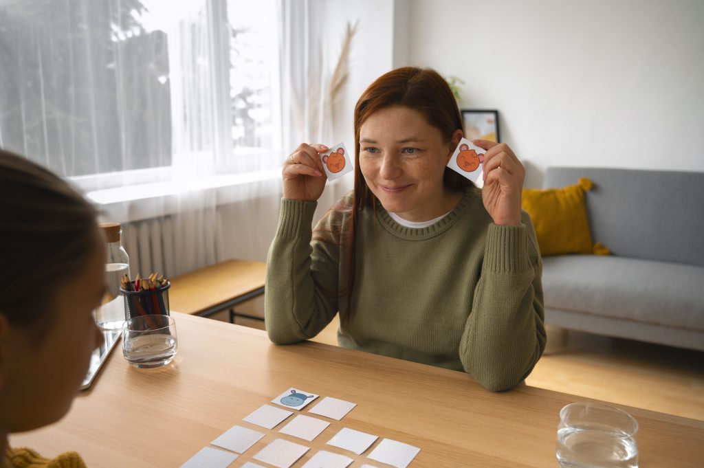 Therapist holding emotion cards during a child-focused therapy session