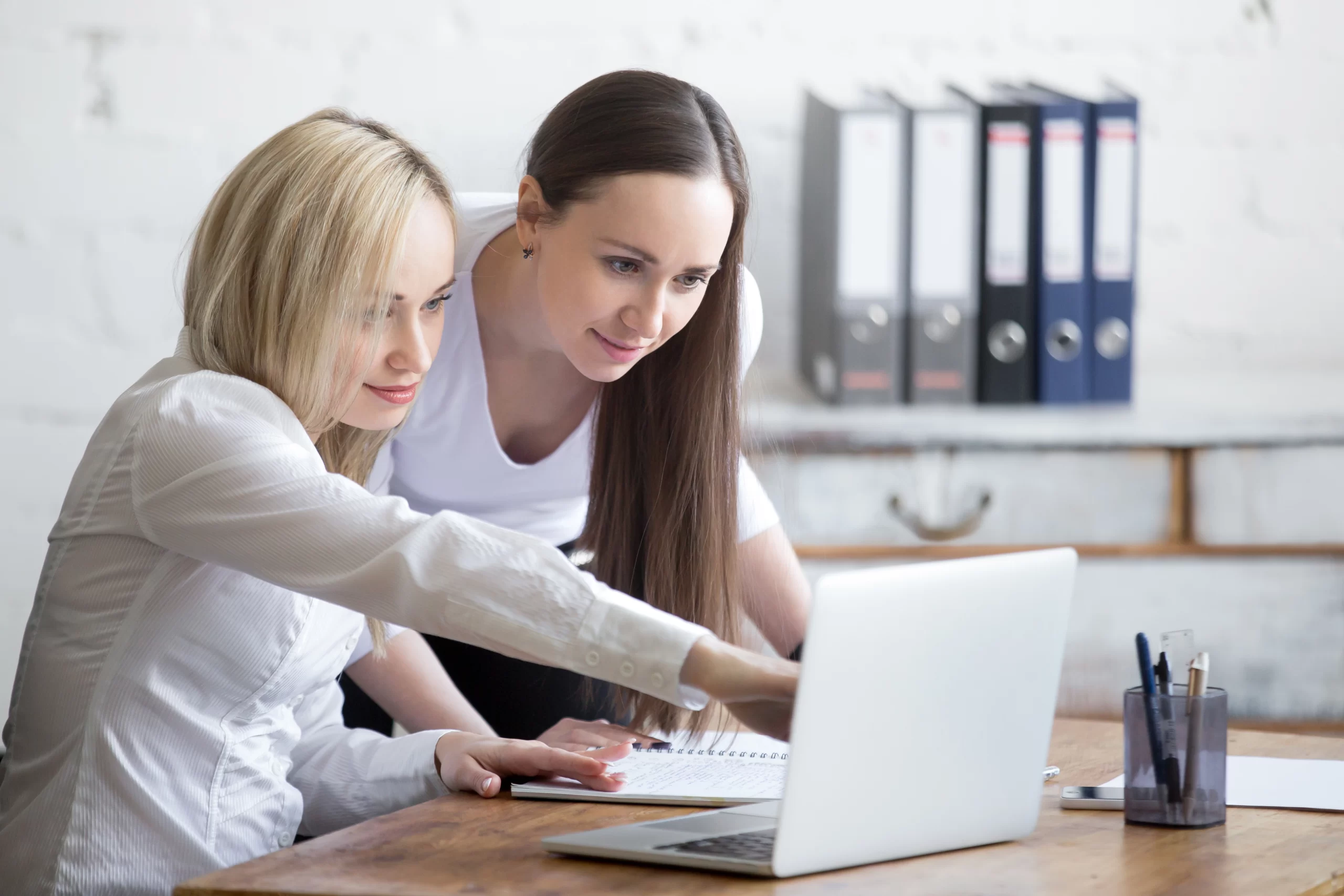 Two aesthetics professionals discussing which career route to take