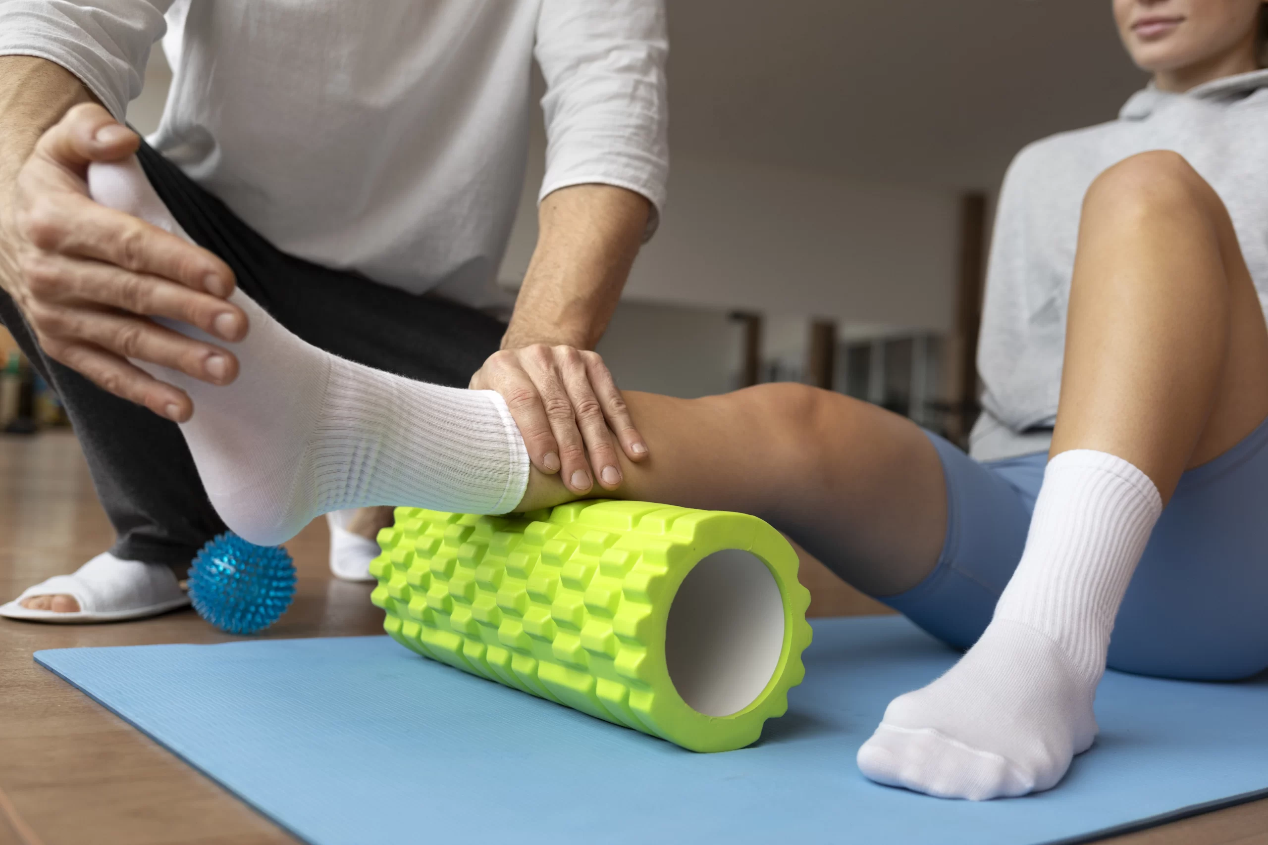 Physical therapist guiding a patient through seated rehabilitation exercises