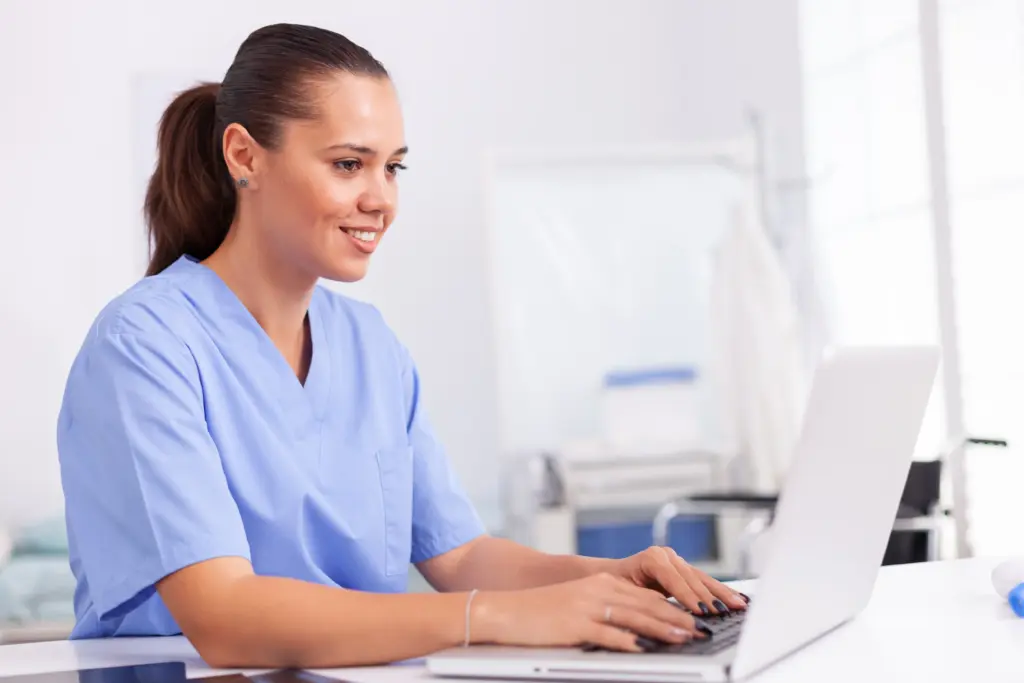 aesthetic nurse working on a laptop
