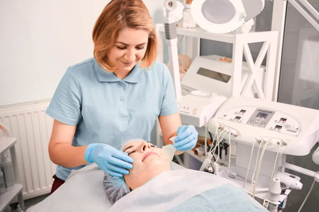 Esthetician performing a treatment to patient