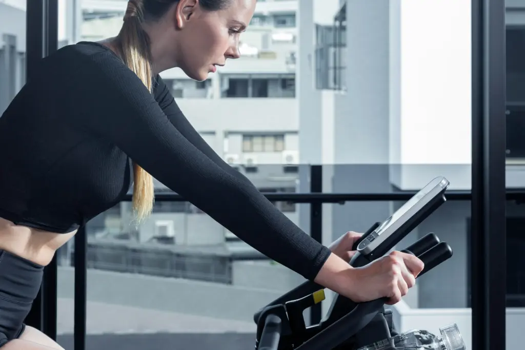 woman uses a static bike, commonly used for Wingate test