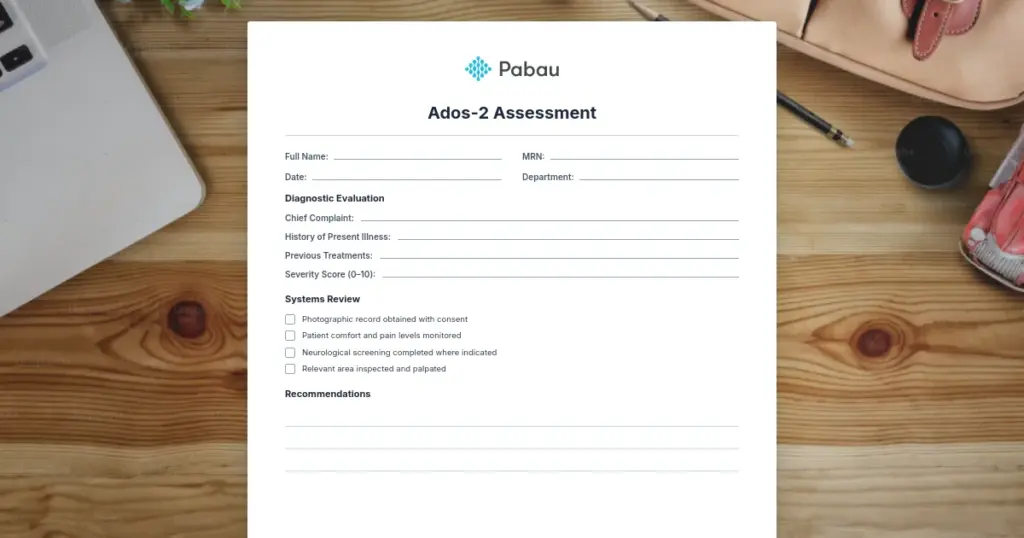 Blank Pabau-branded clinical assessment form headed ADOS-2 assessment, lying on a wooden desk