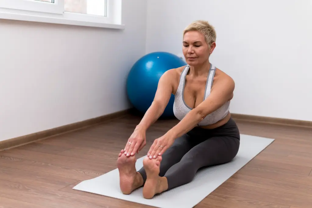 senior woman indoors doing stretching exercises