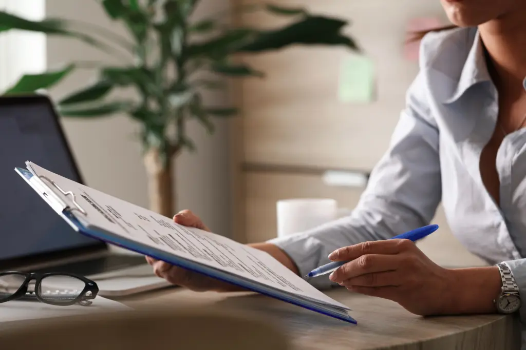 female entrepreneur analyzing business reports while working on paperwork in the office