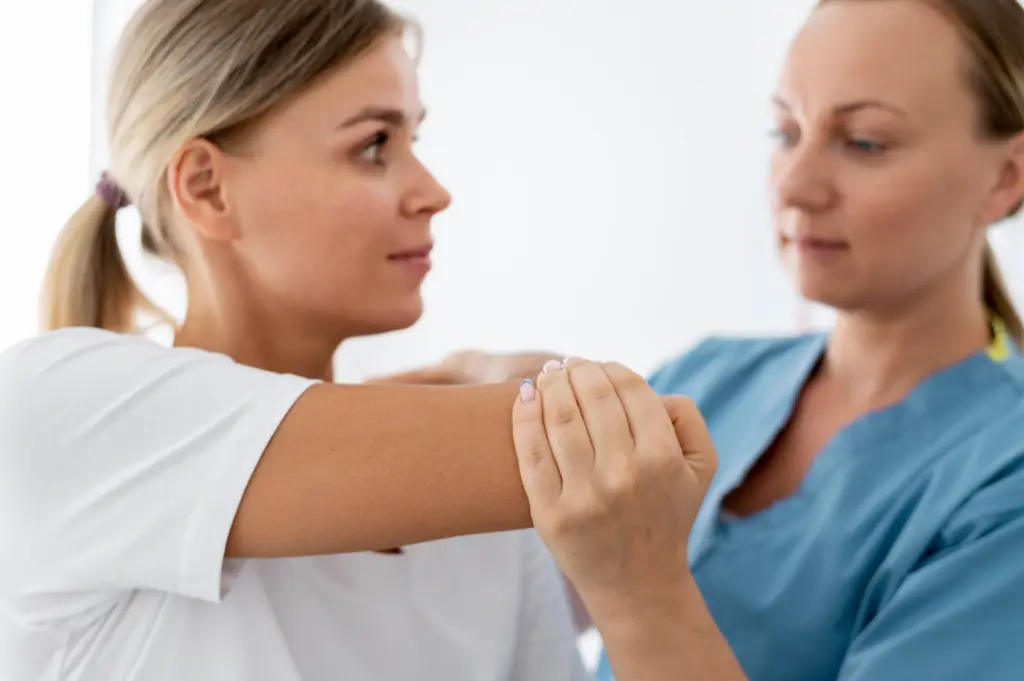 Physiotherapist helping a young female patient at her clinic.