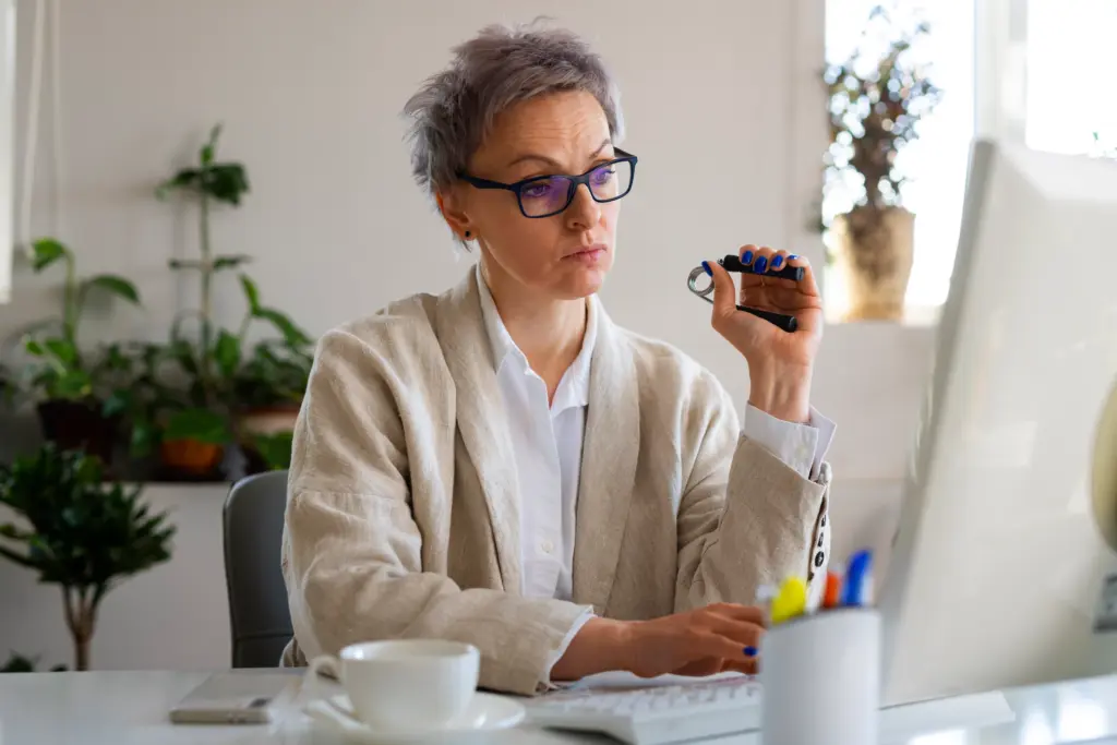 Medium shot woman sitting at desk.